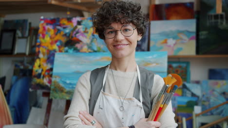 portrait of a smiling artist in an art studio