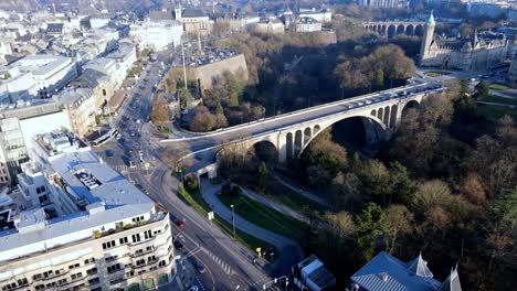 reveal drone shot over luxembourg city center bridge golden lady