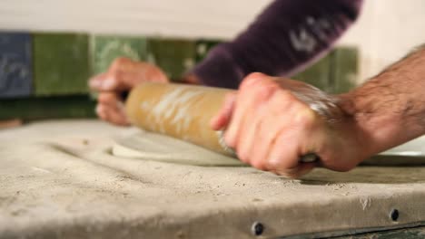 Male-potter-molding-clay-with-rolling-pin