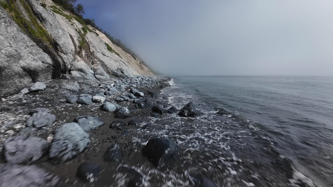 A breathtaking journey along a rocky coastline revealing steep cliffs and gentle ocean waves