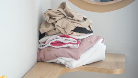 pile of clothes on a shelf