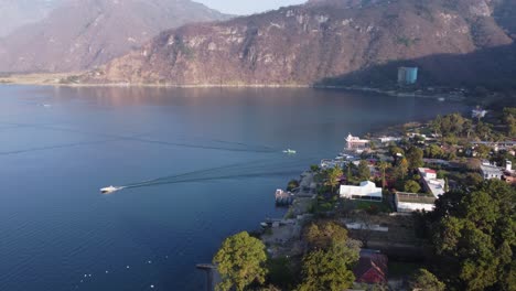 aerial tilts down: jaibalito village on lake atitlan shore, guatemala