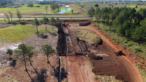 backward dolly view over a construction area as land grading work begins