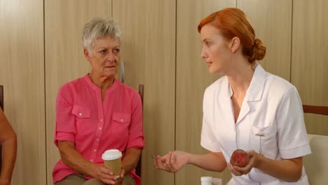 therapist talking to two senior women