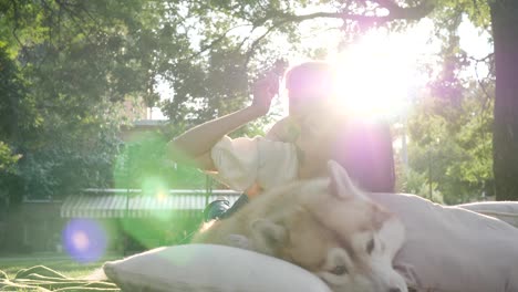 family hugs the hound close-up in backlight on background of nature