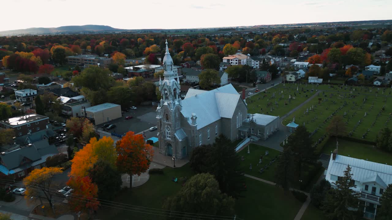 aerial shot revealing St Matthieu Church in Beloeil city and the landscape in the background during fall season in greater montreal aera in Quebec province, Canada