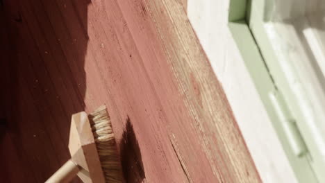 traditional swedish falu red house old peeling paint brushed off for renovation