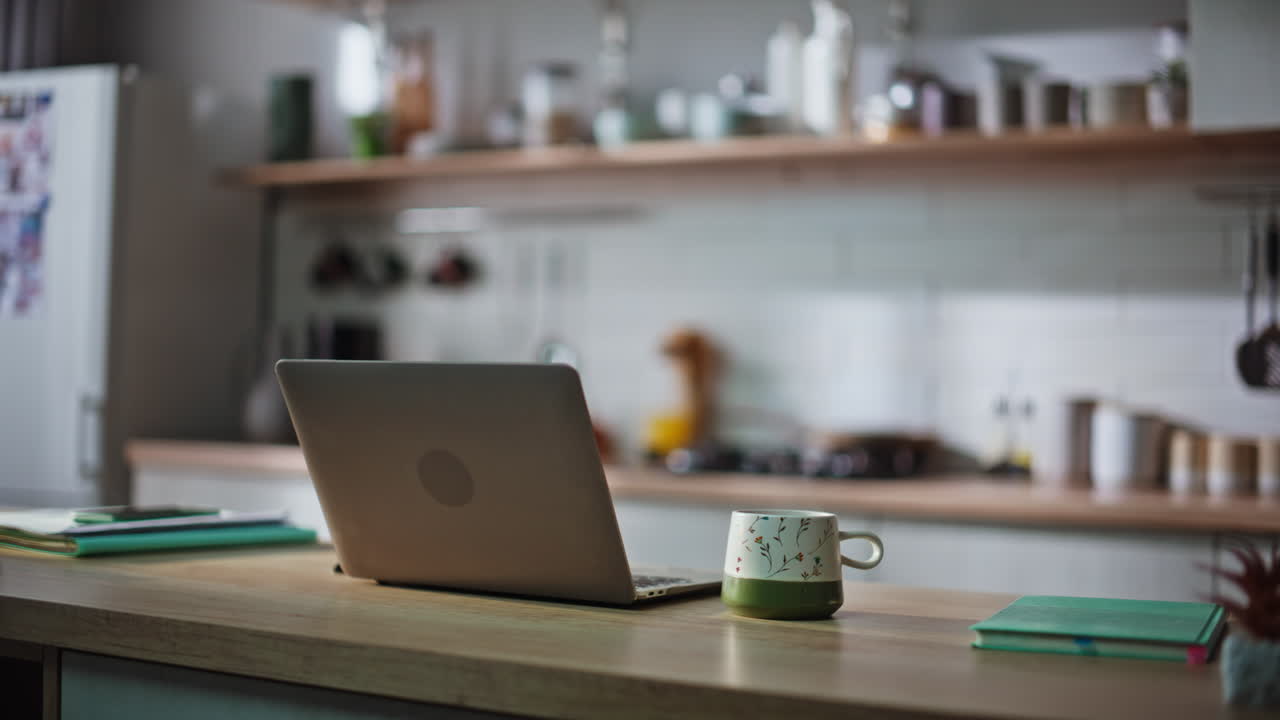 Organized home workspace laptop in remote kitchen office closeup. Online work