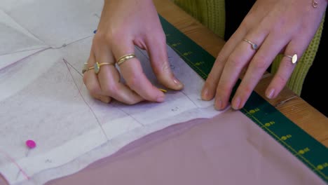 fashion designer pinning on cloth in fashion studio 4k