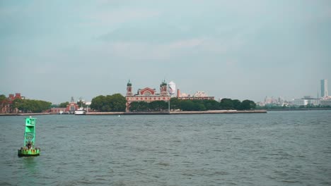 Sailing In Upper New York Bay With Distant View Of Immigration Museum At Ellis Island In New York Harbor - POV, wide shot