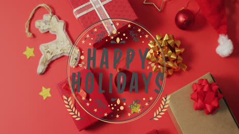 animation of happy holidays text over christmas decorations