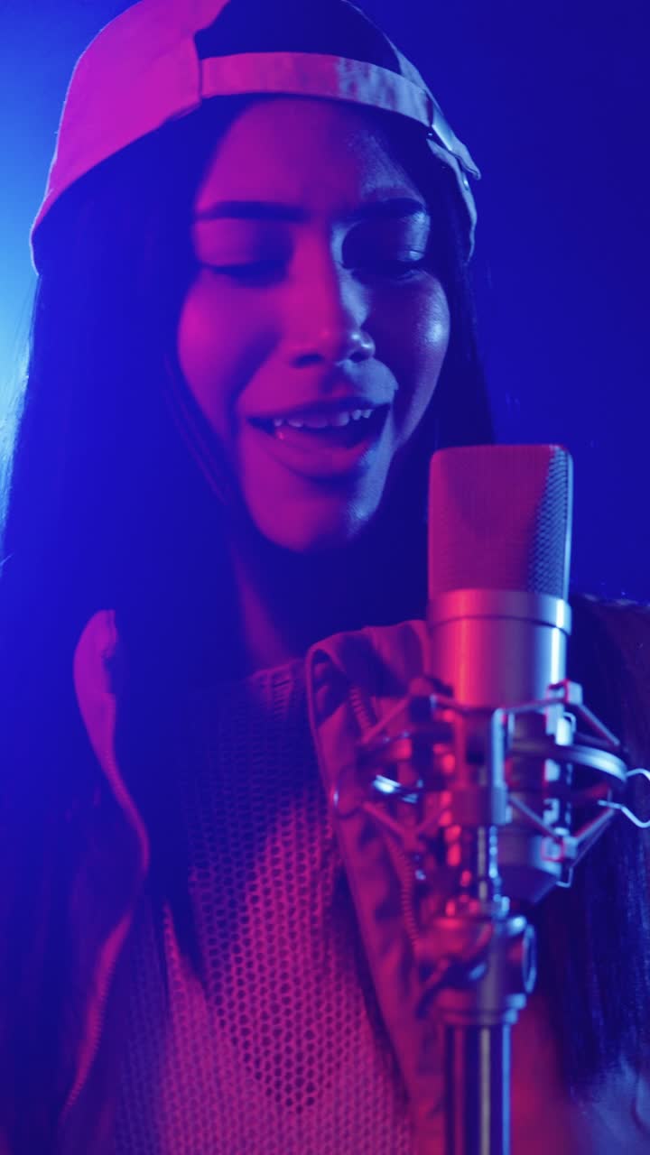 Woman singing into a microphone