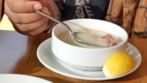 woman eating soup