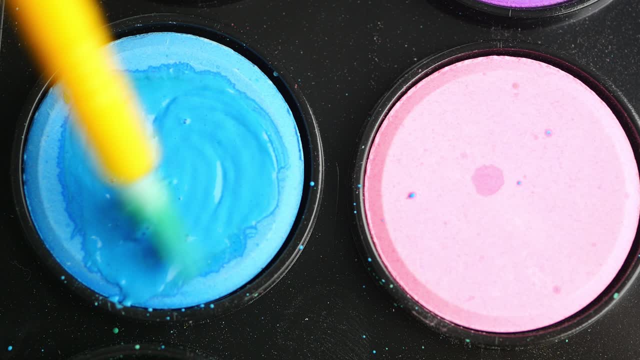 Watercolor painting with a paintbrush and palette