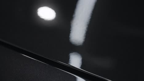 close-up of a black car's polished paint