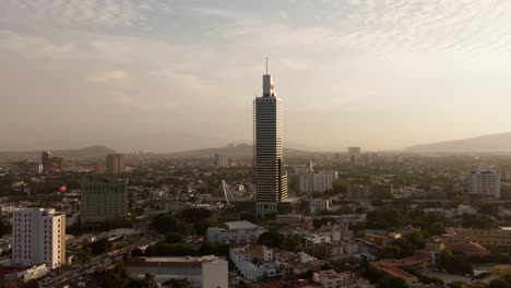 drone zoom out dolly out shot of riu hotel in guadalajara at sunset