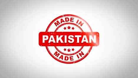 made in pakistan signed stamping text wooden stamp animation. red ink on clean white paper surface background with green matte background included.