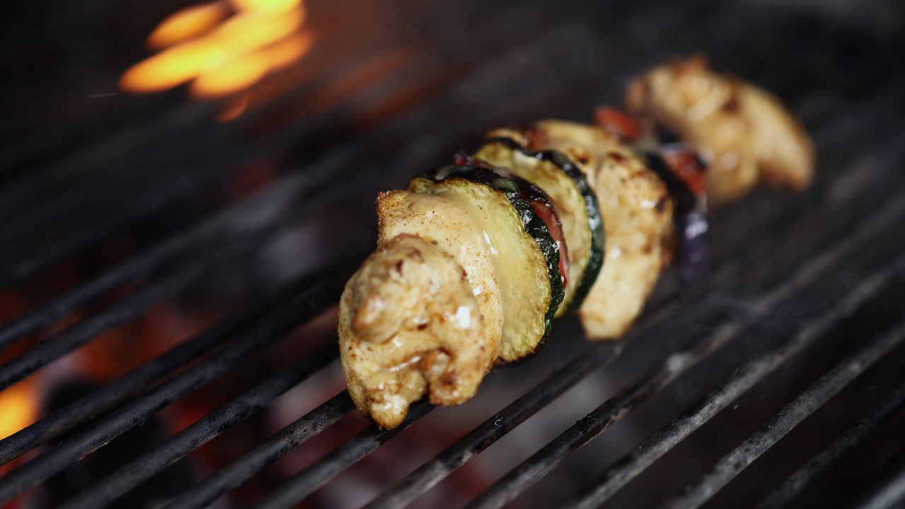 A Pork Barbecue Grilled Above The Heat Of A Charcoal With Small Fire In The Griller - Close Up Shot