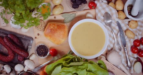 Soup-In-Bowl-Amidst-Various-Ingredients-Assorted-On-Wooden-Table-4