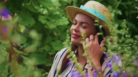 woman enjoying nature in a vibrant garden surrounded by colorful flowers and greenery