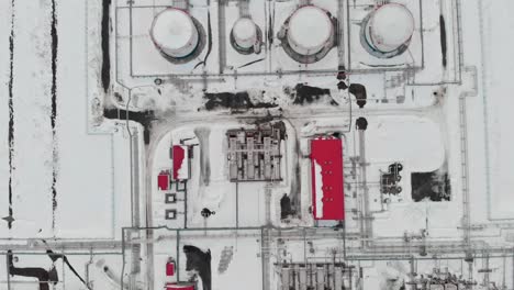 a drone flies over an oil storage facility in siberia. oil reserves in the race of oil and gas tanks in winter. fuel crisis due to sanctions against the russian fuel industry. oil and gas industry.