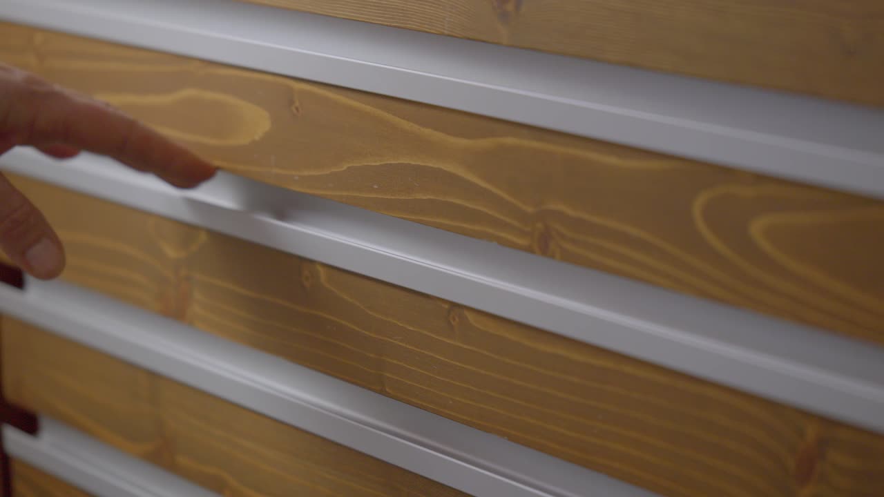 Hand opening a shelf containing glasses in an optical shop