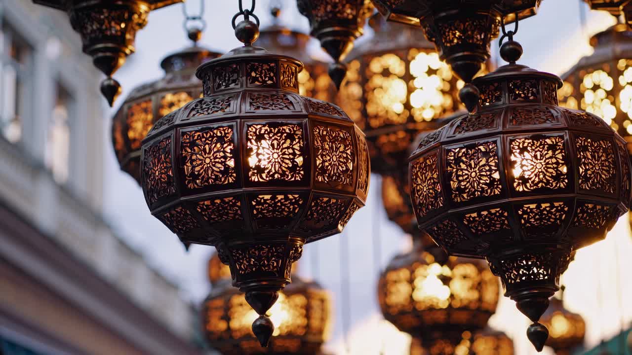 Ornate metal lanterns with intricate patterns, glowing warmly