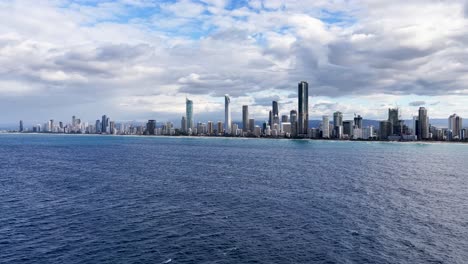 Dynamic hyperlapse capturing Gold Coast's skyline with shifting clouds and ocean waves, showcasing urban and natural beauty
