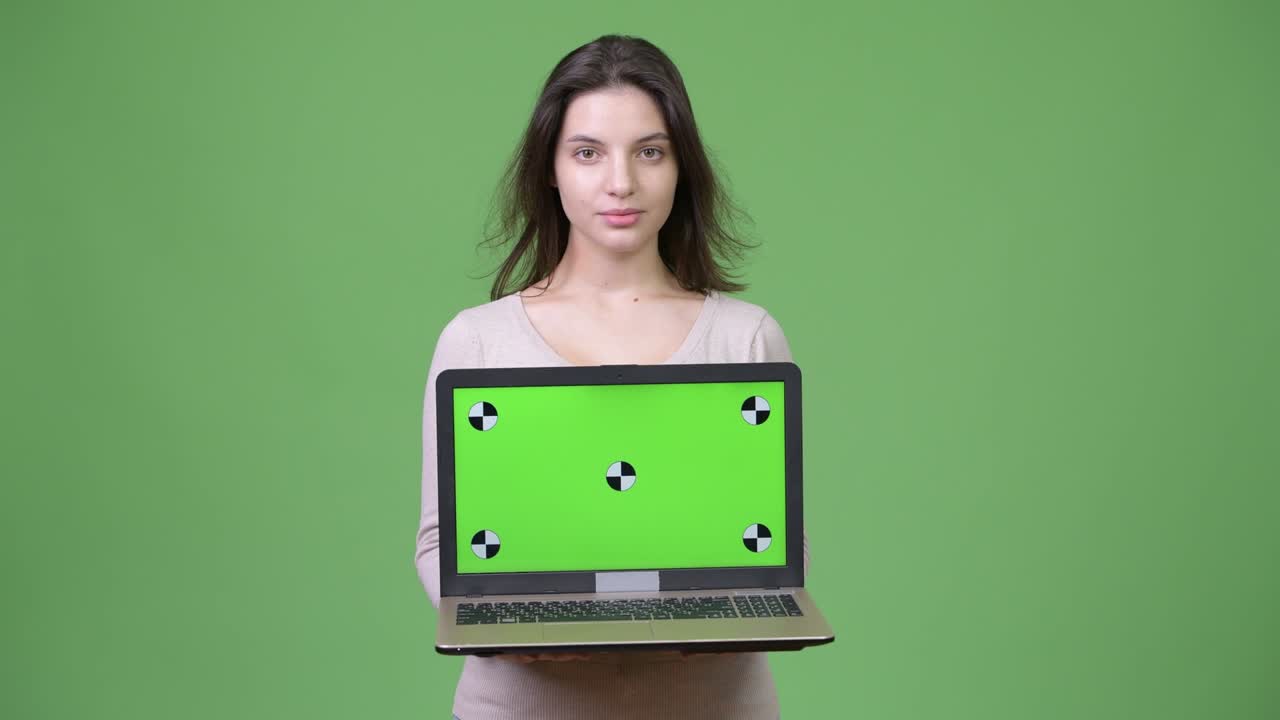 Young beautiful woman showing laptop