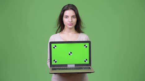 young beautiful woman showing laptop