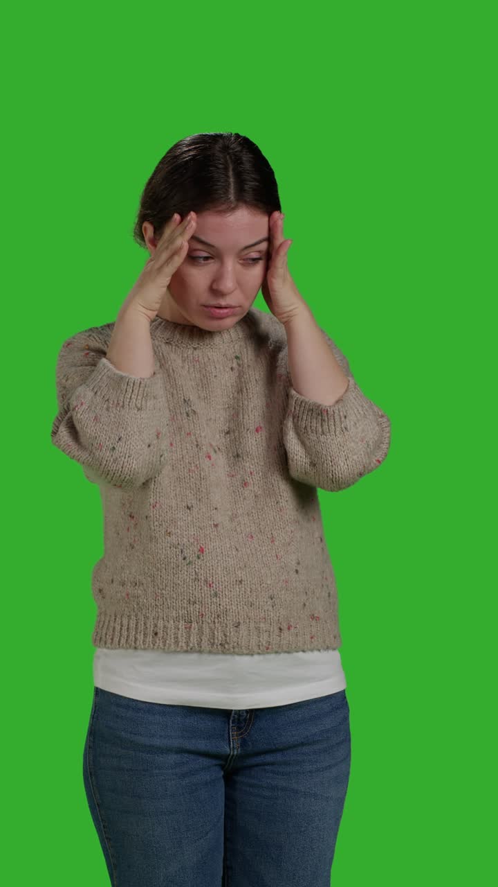Vertical video: Front view close up of adult dealing with painful headache