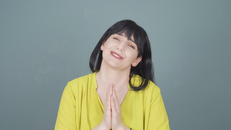 Woman apologizing looking at camera.