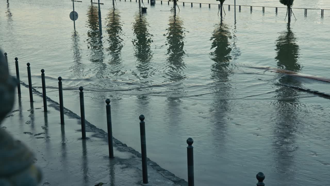 Flooded street barriers and reflections of trees in the Danube during Budapest Flood 2024