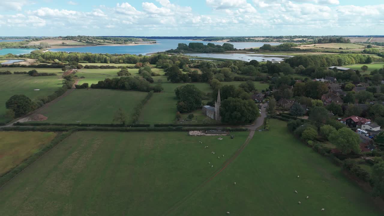 Aerial view of fields and St. Edmund’s church in Egleton, UK, peaceful mood