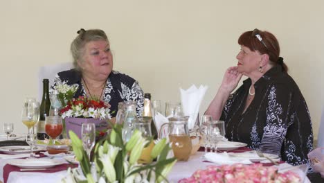 seniors celebrating 70th anniversary at festive dinner table in restaurant