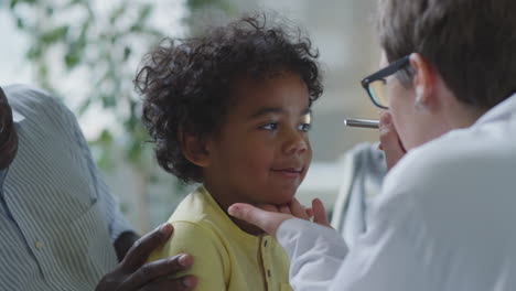 child getting a medical examination from a pediatrician