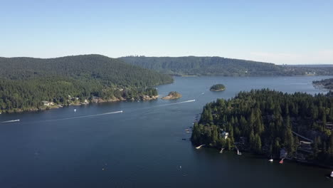 high aerial: ocean front properties, boats in passage on canada coast