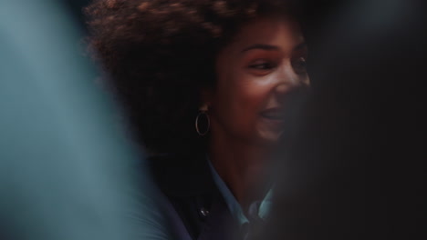 beautiful-woman-with-afro-hairstyle-hanging-out-with-friends-in-restaurant-laughing-enjoying-conversation-socializing-at-party-gathering