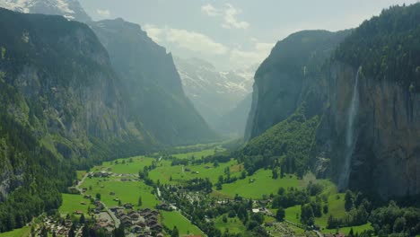 aerial pan up of lauterbrunnen valley, switzerland with epic waterfall