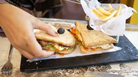 woman eating a sandwich with fries