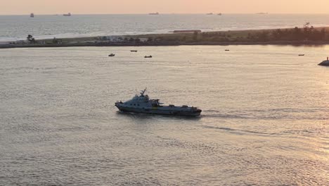 a ship sailing through a channel into the atlantic ocean at sunset in lagos nigeria