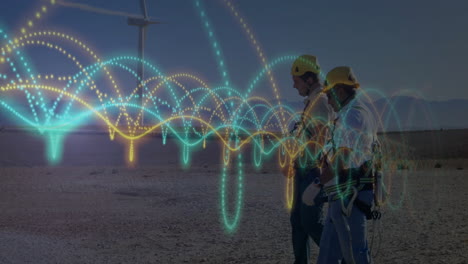 two male technicians walking across wind farm with safety helmets and digital arcs visualizing data