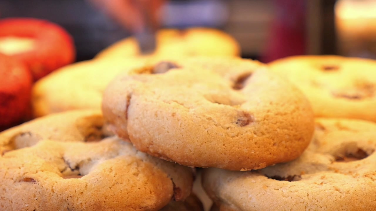 Close-up of Hand Picking Up a Delicious Cookie
