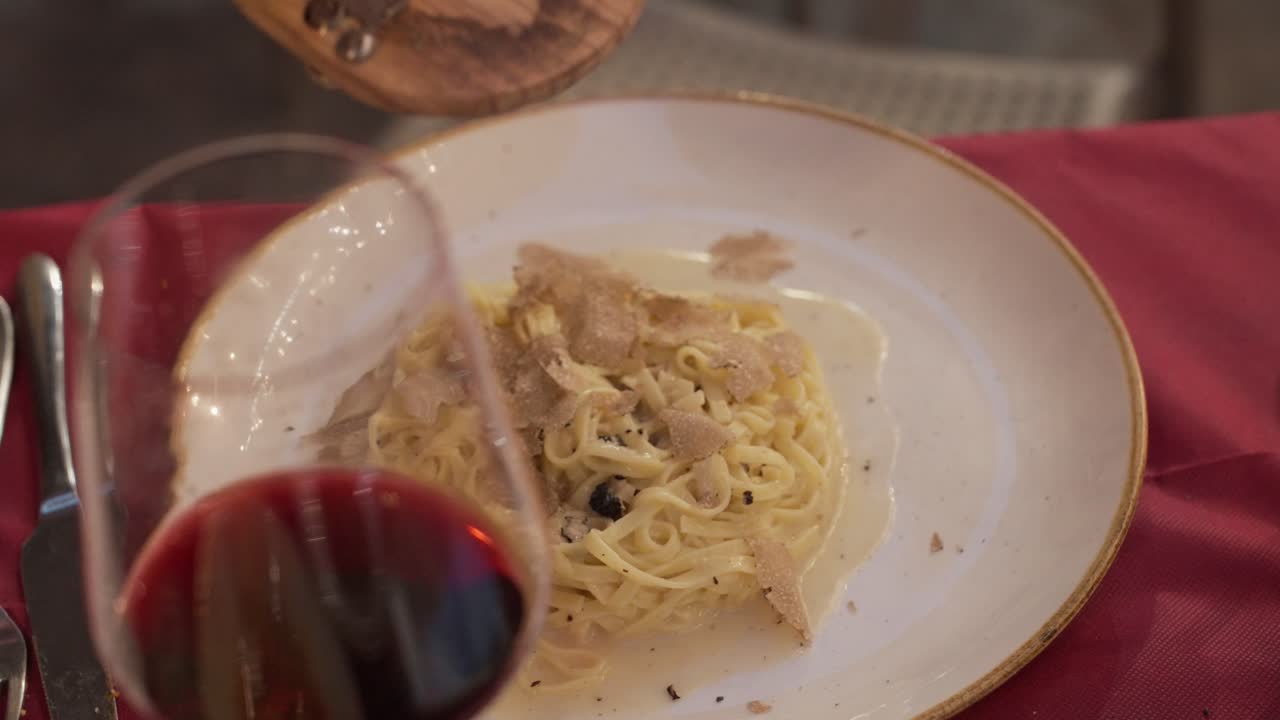 Fresh truffles are shaved onto a plate of pasta in Siena, Italy.