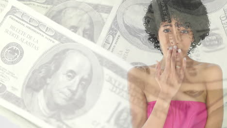 animation of a woman covering her mouth over american dollar bills spinning.