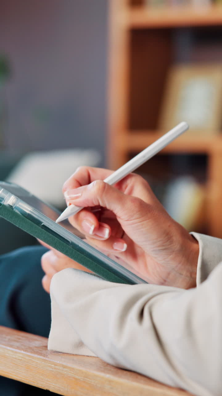 Hands writing on tablet