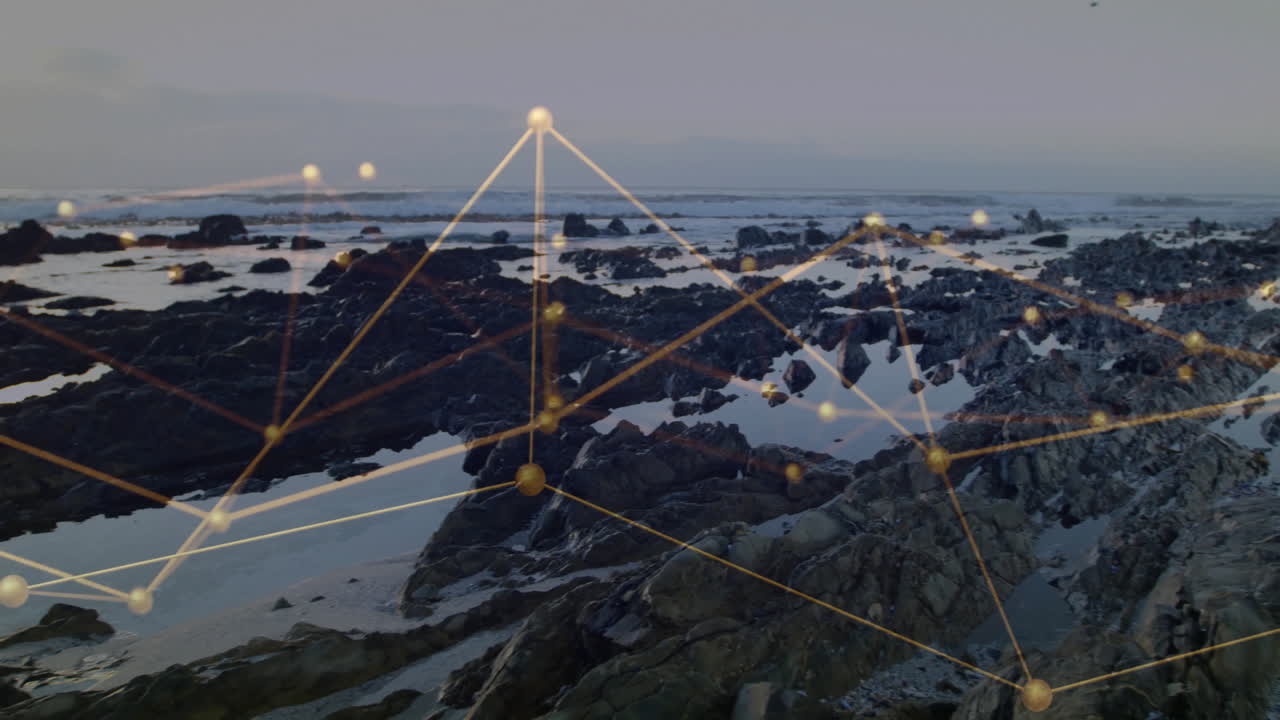 Flat design network overlay floating above rocky shoreline, with golden nodes and luminous lines
