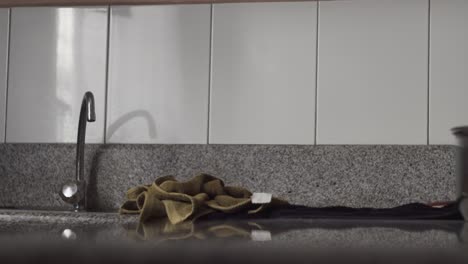 Cropped-Image-Of-A-Person-Getting-The-Washed-Bellpepper-On-Towel-From-Kitchen's-Countertop