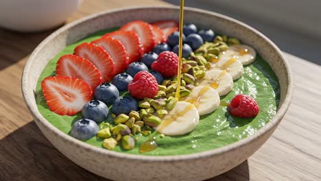 a colorful and nutritious smoothie bowl topped with fresh fruits, nuts, and drizzled honey, perfect for a healthy breakfast or snack