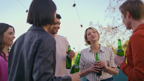 smiling colleagues relaxing together at rooftop closeup. people enjoying party